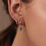 Load image into Gallery viewer, MURKANI - Huggie with Hanging Blue Topaz  Baguette in Sterling Silver
